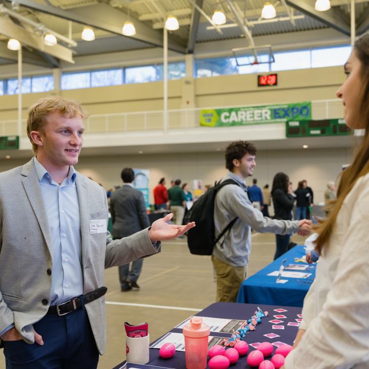 A student talks to an employer at the career expo.